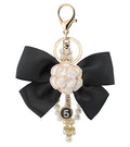 Camellia Flower Purse Charm Keychain with Bow and Pearl Accents - color: White